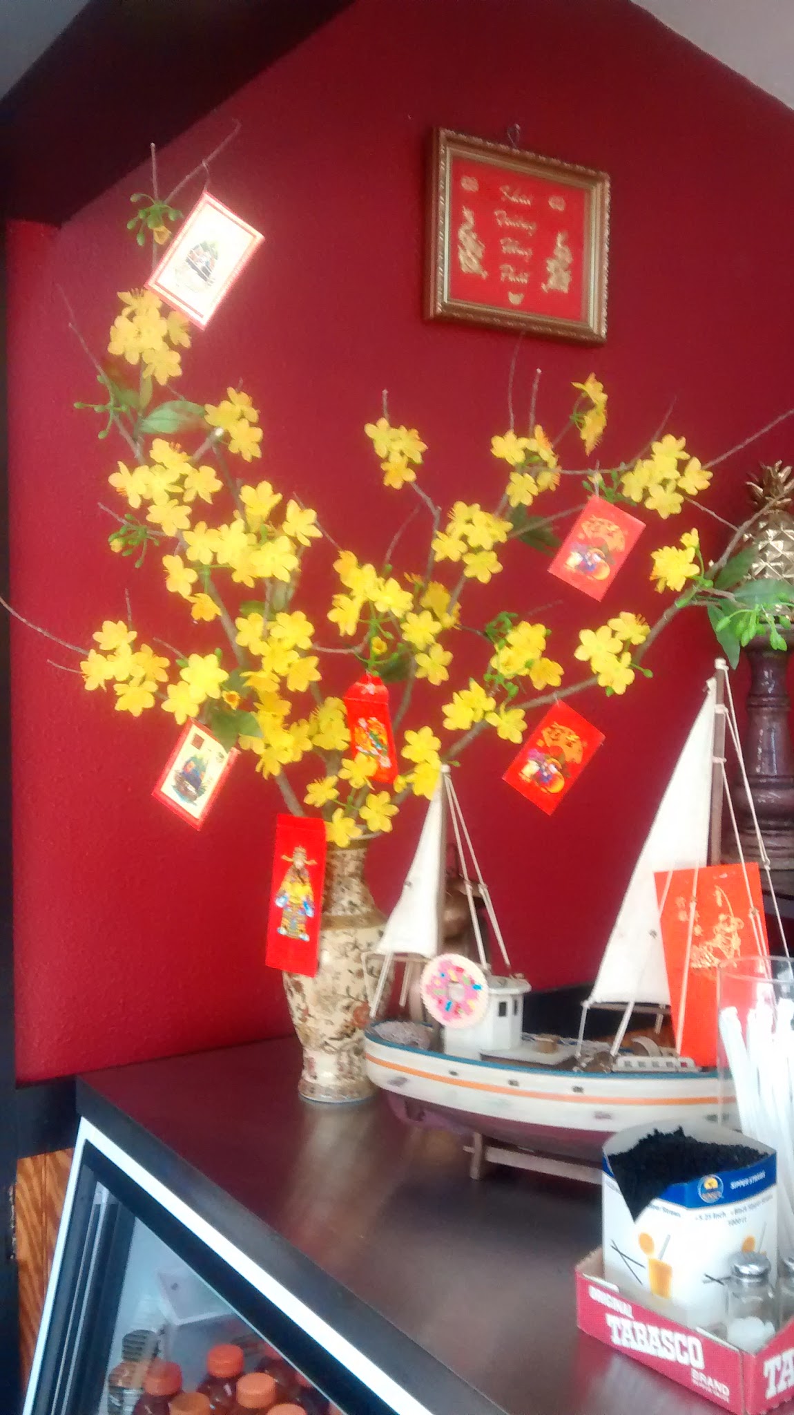 Vietnamese decor with mai flowers and lucky envelopes